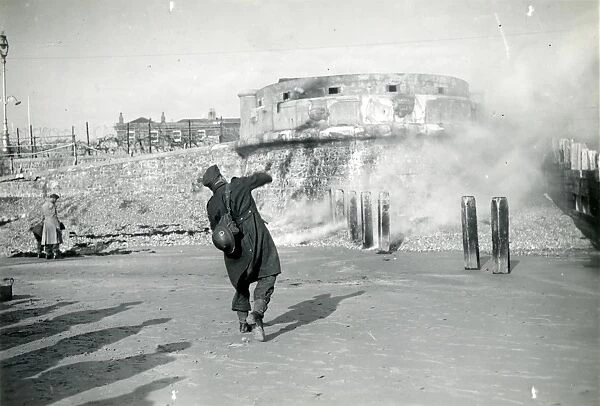 Bognor Regis: soldier throwing gas canister on the beach 1939-1945