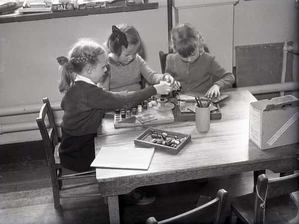 Three girls during art lesson at Lancastrian Infants School, Chichester, May 1956