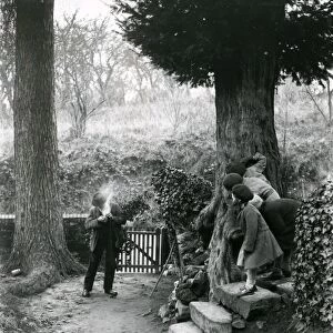 Country man lighting his pipe at Upperton, December 1935
