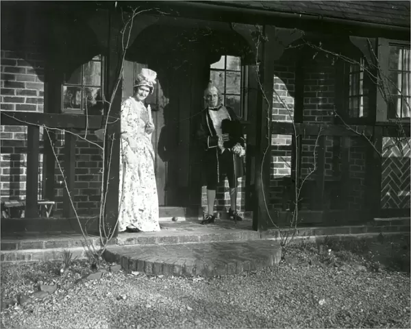 Lady and Gentleman in costume standing on a balcony, February 1938