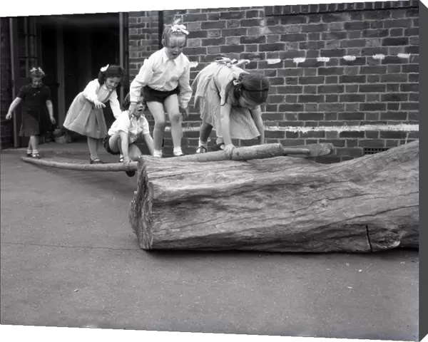 School children on a log at Lancastrian Infants School, Chichester, May 1956
