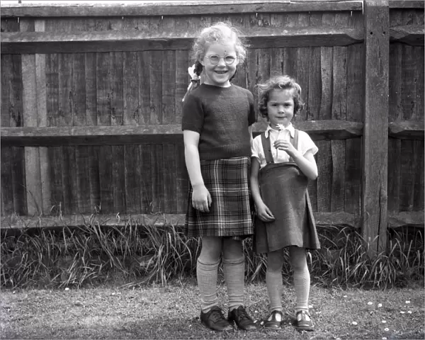 Two girls in playground of Lancastrian Infants School, Chichester, May 1956