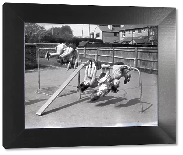 Children upside down on climbing frame, Lancastrian Infants School, Chichester, May 1956