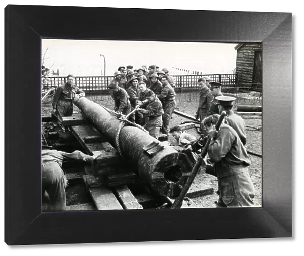Bognor Regis: men of Royal Artillery moving barrel of gun