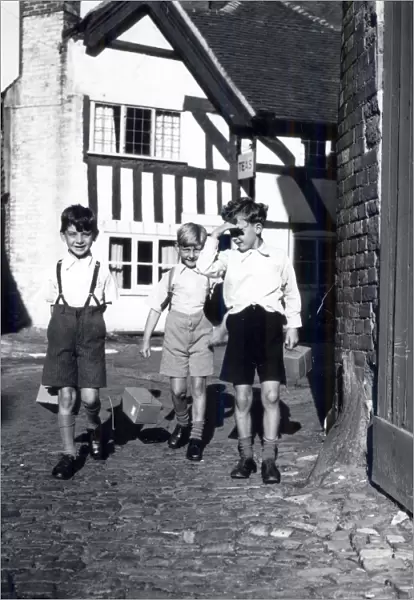 Three evacuees with gasmask boxes, September 1939