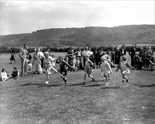 Childrens skipping race with onlookers, June 1953