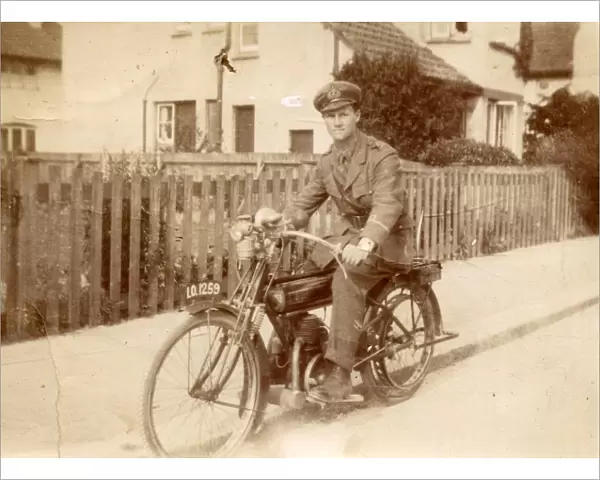 Young man in military uniform on motorbike, c1920s