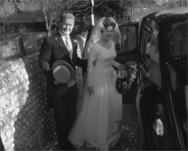 Bride and Groom posing by limousine