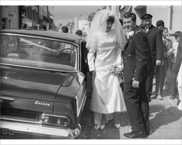 Bride and Groom on Wedding Day standing next to Wedding car