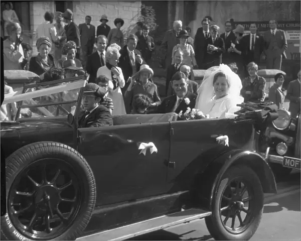 Bride and Groom in open top motor car