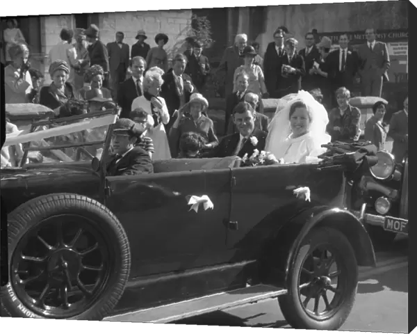 Bride and Groom in open top motor car