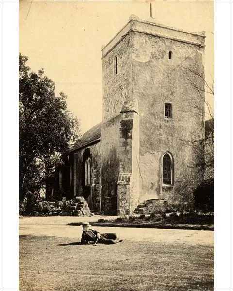 Well-dressed man reclining on the lawn in front of the church at Beeding, 23 March 1893