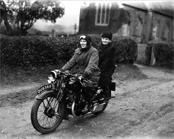 Two ladies riding a motorbike