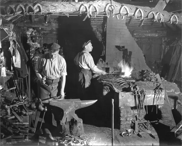 Fittleworth Smithy interior with two blacksmiths