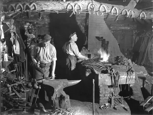 Fittleworth Smithy interior with two blacksmiths