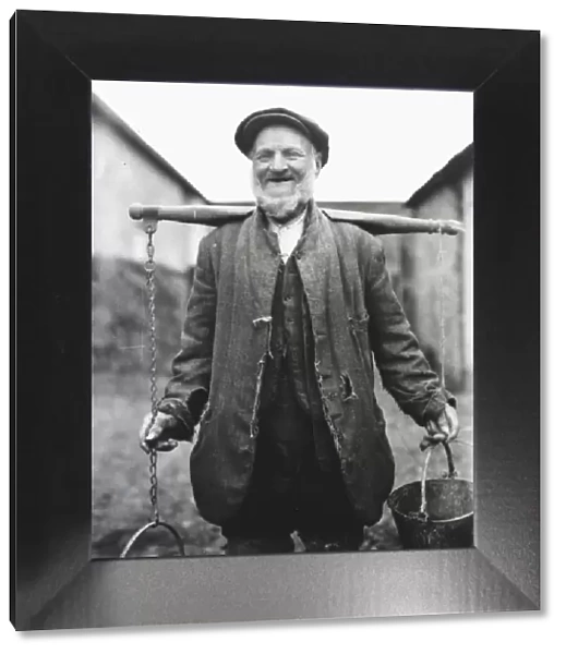 Farm worker with buckets on a yoke, Lavant, Sussex
