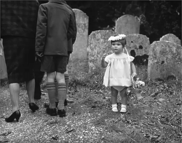 Little bridesmaid in churchyard