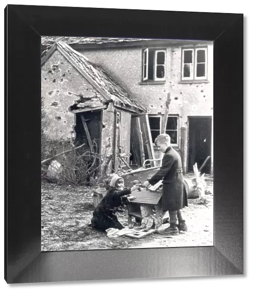 Children playing in garden of bombed-out house, [Dec 1940]