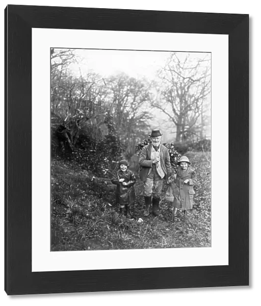 Gentleman and two children bringing home the holly, Petworth, West Sussex