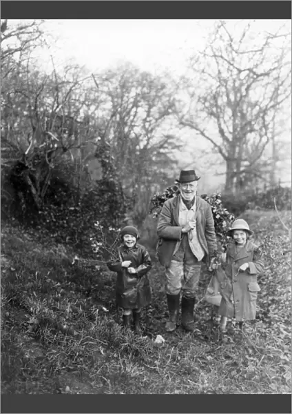 Gentleman and two children bringing home the holly, Petworth, West Sussex