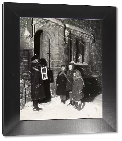 Carol singers in the snow at Soanes farmhouse, Sussex