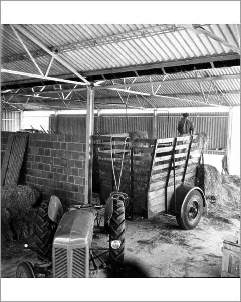 Old tractor and cart in a barn