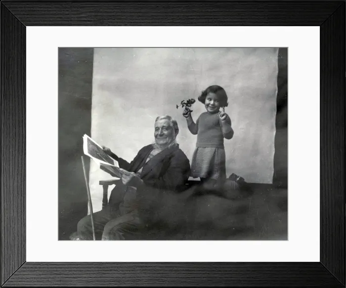 Framed Print : Elderly gentleman and young girl with mistletoe