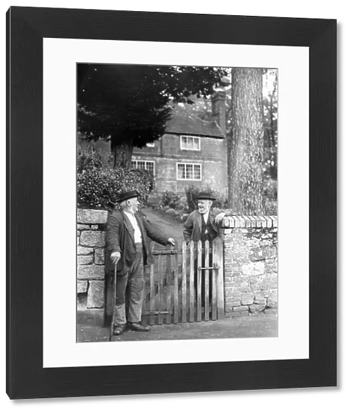 Two elderly gentlemen chatting over a gate at Upperton, Sussex, 1935