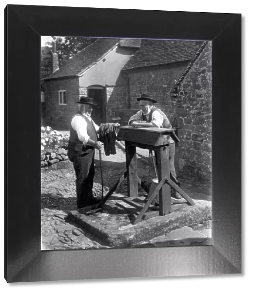 Two country gentlemen chatting by a well at Upperton, Sussex. August 1936