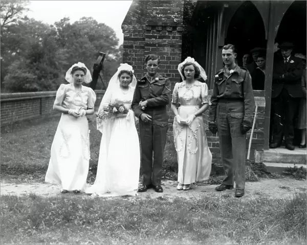 Bridal party, groom and best man in army uniform at Ebernoe, Sussex, 1940s