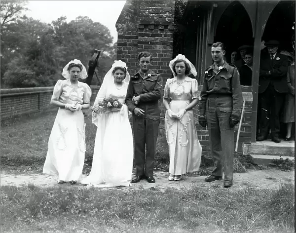 Bridal party, groom and best man in army uniform at Ebernoe, Sussex, 1940s