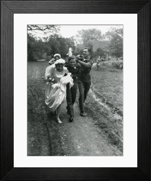 Framed Print : Bride and Groom being showered by confetti, 1940s Framed Print : Bride and Groom being showered by confetti, 1940s