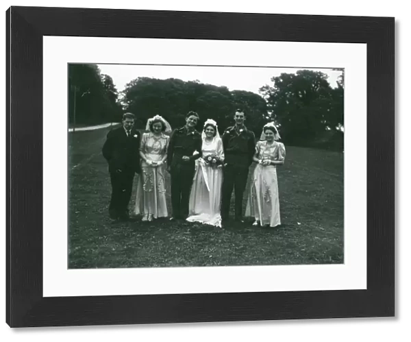 Wedding party posing in church grounds at Ebernoe, Sussex, 1940s