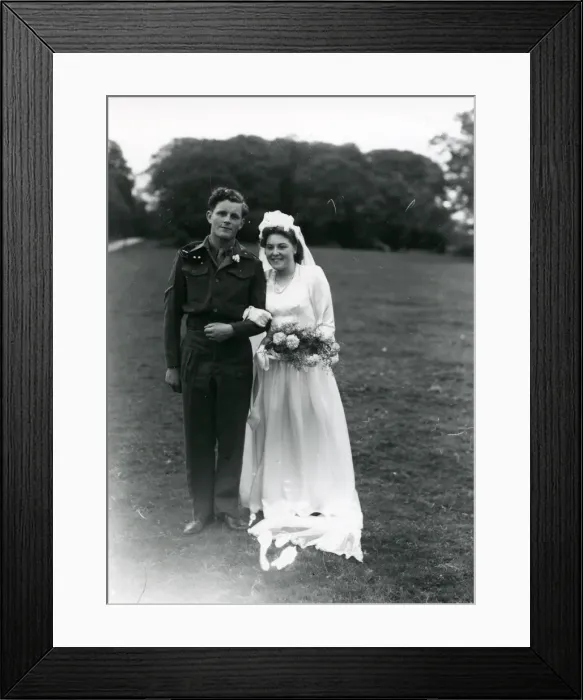 Framed Print : Bride and Groom posing in church grounds, 1940s Framed Print : Bride and Groom posing in church grounds, 1940s