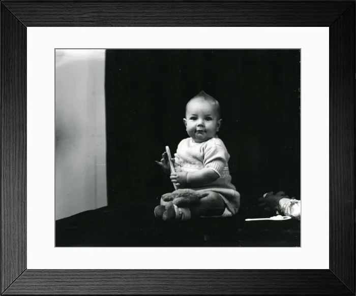 Framed Print : 1940s portrait of a baby posing with toys Framed Print : 1940s portrait of a baby posing with toys