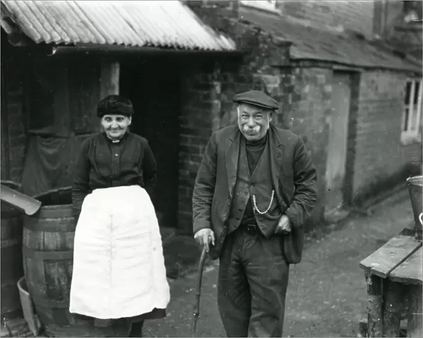 Elderly couple outside their country cottage in Sussex