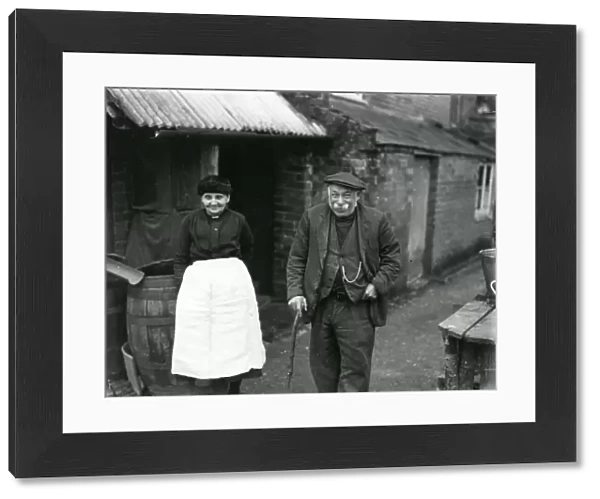 Elderly couple outside their country cottage in Sussex