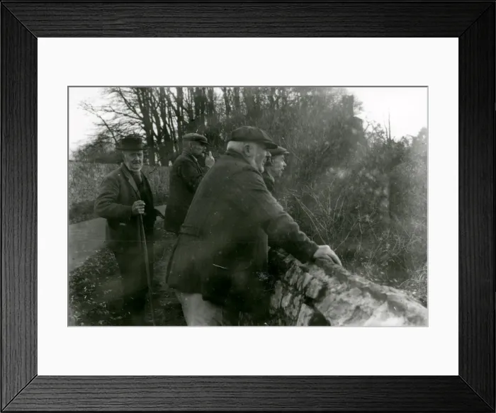 Framed Print : Elderly gentlemen leaning over flint wall Framed Print : Elderly gentlemen leaning over flint wall