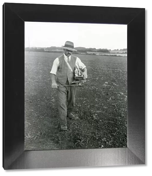 Farm worker fiddling trifolium [clover] seed, September 1933