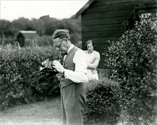 George Garland in a garden with his camera, September 1938