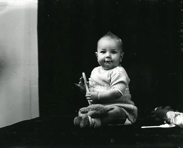 1940s portrait of a baby posing with toys