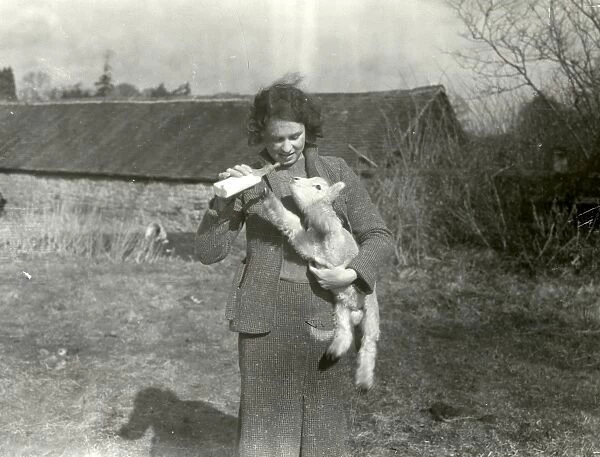 Bottle feeding a lamb at Strood Farm - March 1940