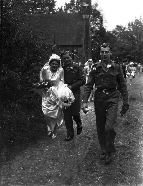 Bridal party walking down church path, Groom in army uniform, 1940s