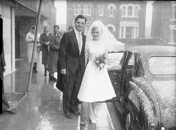 Bride and Groom outside church with snow falling