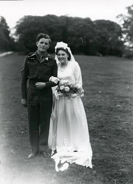 Bride and Groom posing in church grounds, 1940s