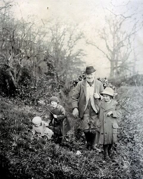 Country gentleman gathering holly with three girls, Petworth, West Sussex
