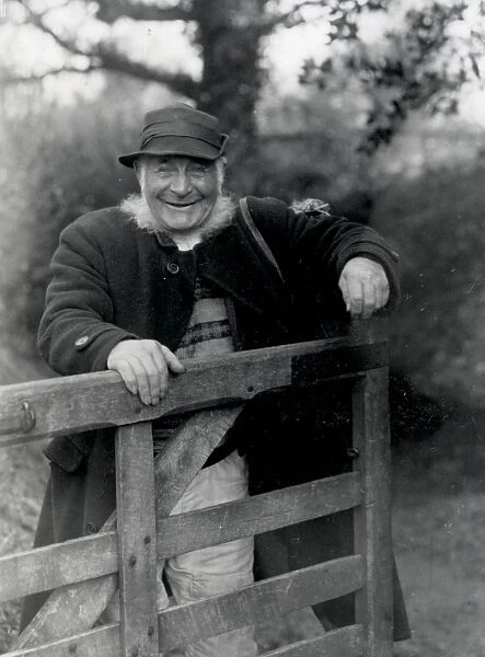 Country gentleman standing behind gate, Upperton, West Sussex