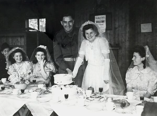 Cutting the cake at wedding reception, Kirdford, Sussex, 1945