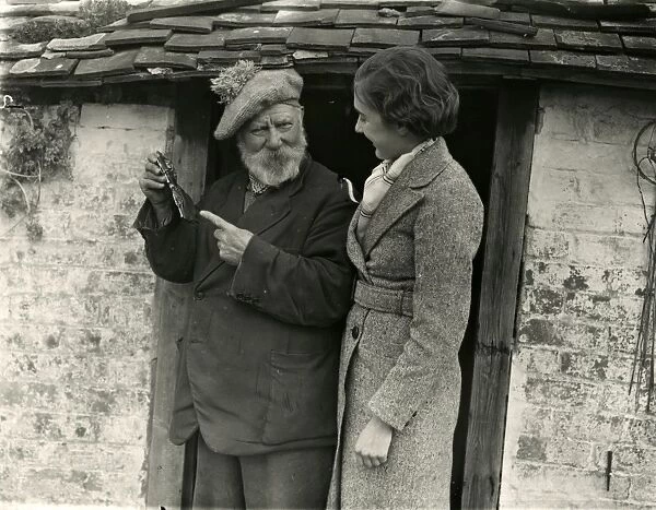 Elderly man and younger lady in conversation, March 1938