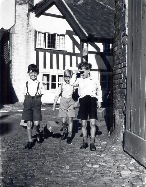 Three evacuees with gasmask boxes, September 1939